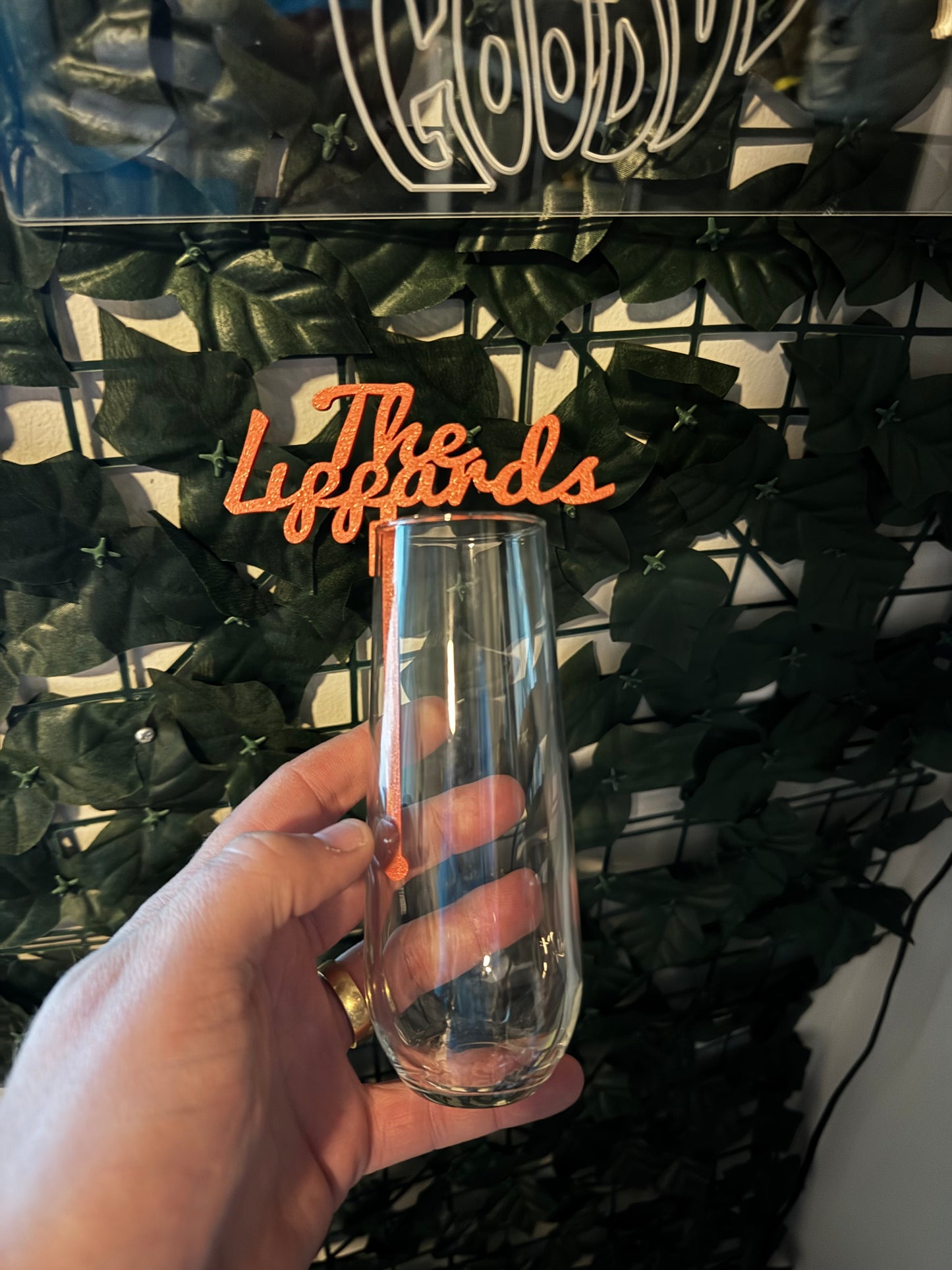 Clay custom wedding drink stirrer with unique design, placed in a beverage for a stylish accent.