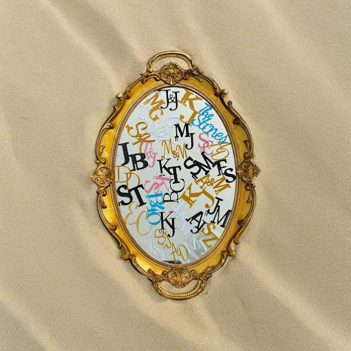Mirror display featuring a variety of custom wedding drink tags in different designs and colors.
