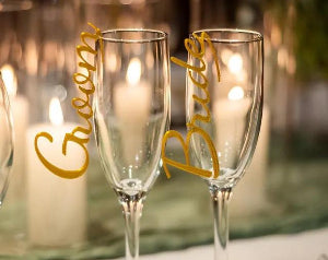 Gold custom wedding drink charm with elegant detailing, adorning a drink for a personalized touch.