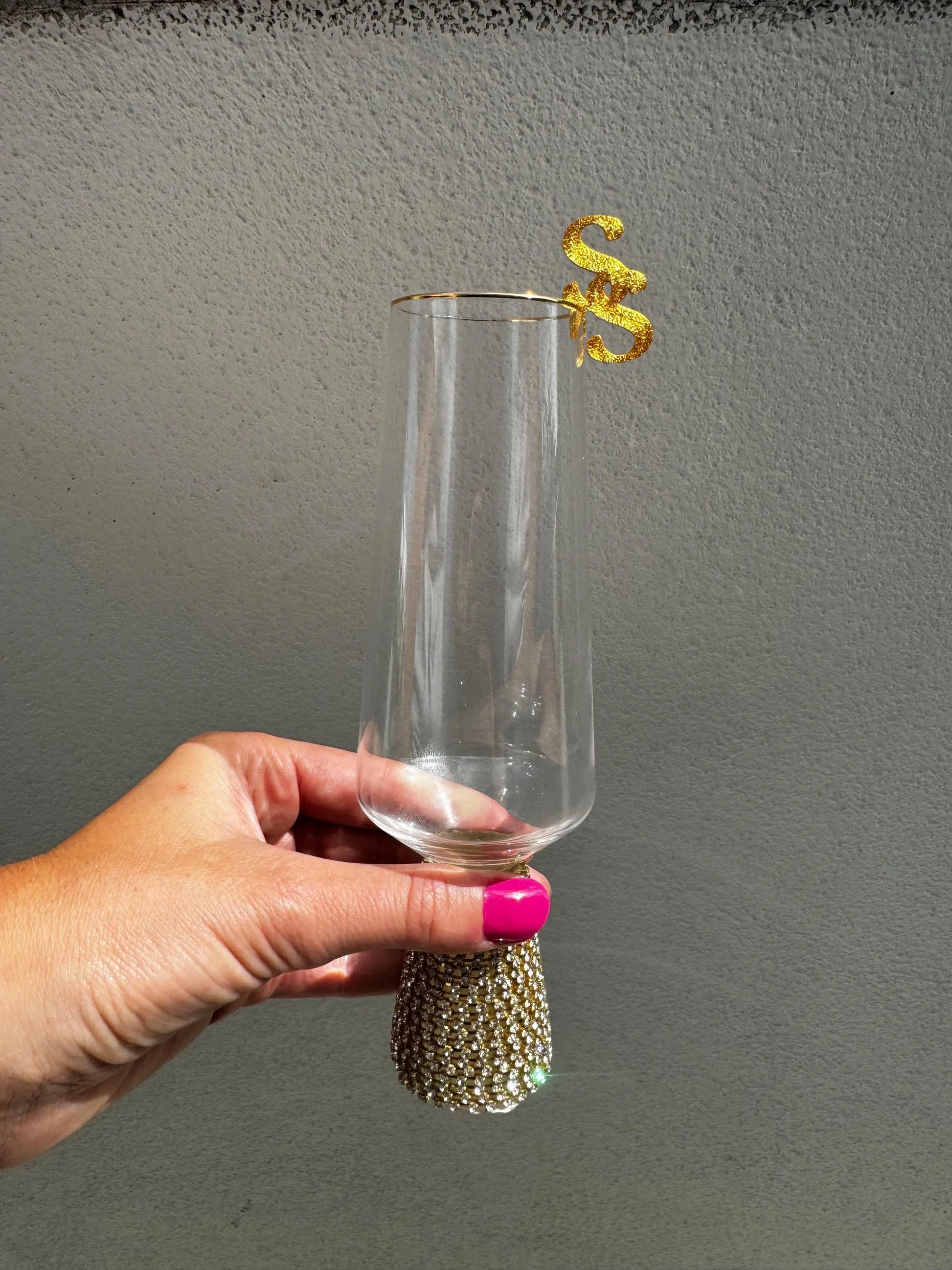 Gold custom wedding drink topper on a cocktail glass, front-facing angle.